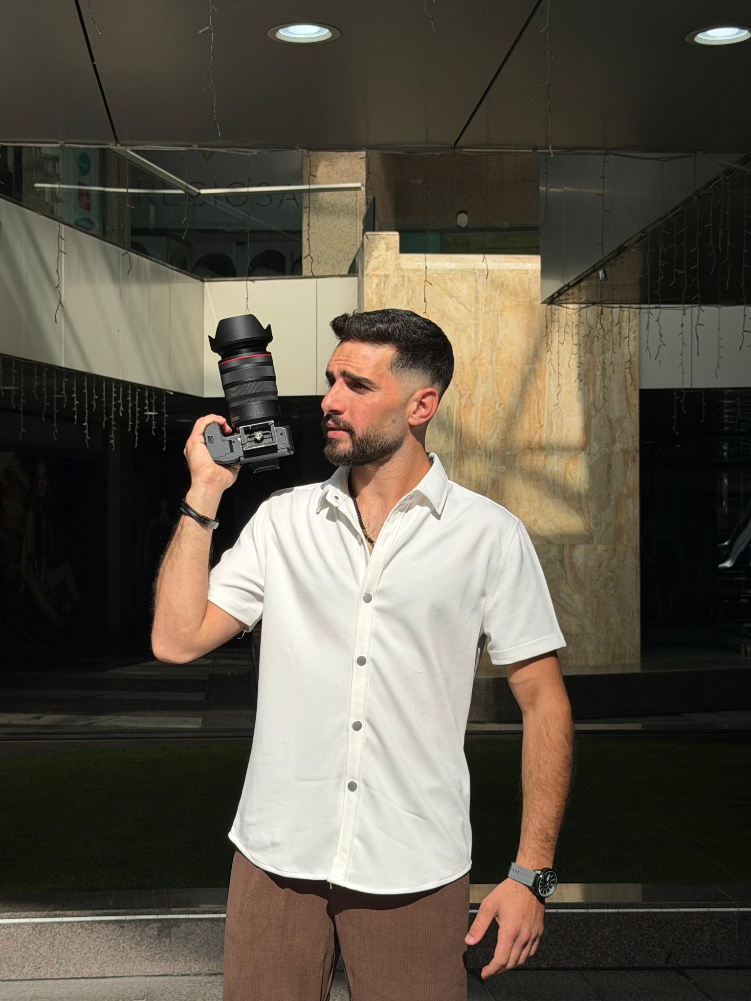 Ragheb Alshoufi holding a camera